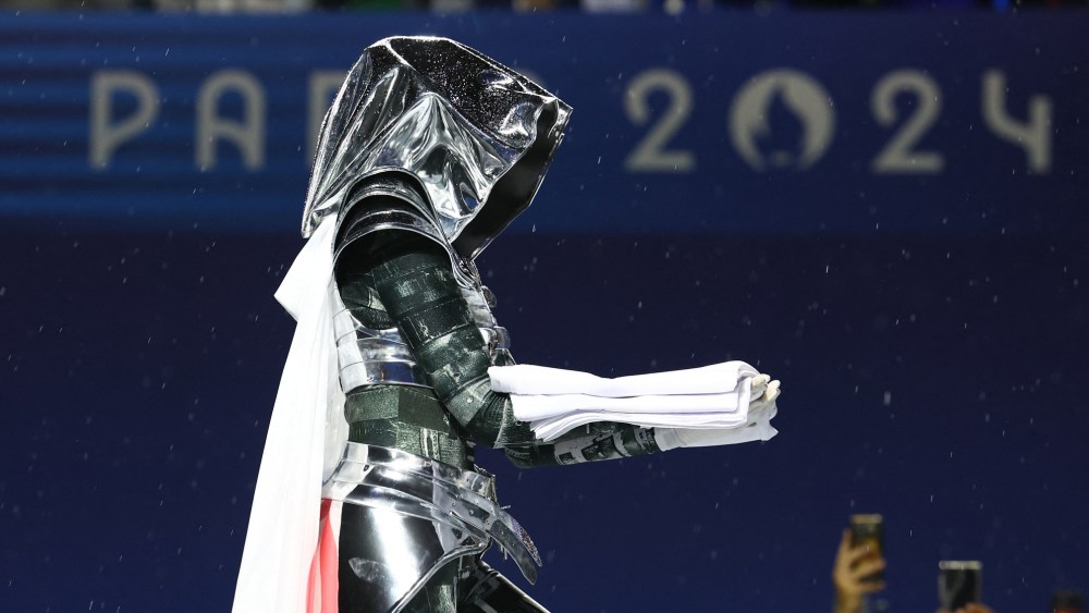 A woman carrying the Olympic flag is seen at the Trocadero during the Opening Ceremony of the Olympic Games Paris 2024