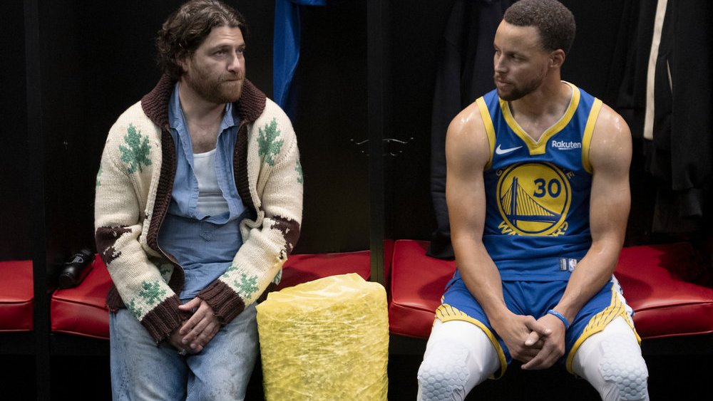 MR. THROWBACK -- "Mr. Throwback" Episode 101 -- Pictured: (l-r) Adam Pally as Danny, Stephen Curry as himself -- (Photo by: David Moir/Peacock)
