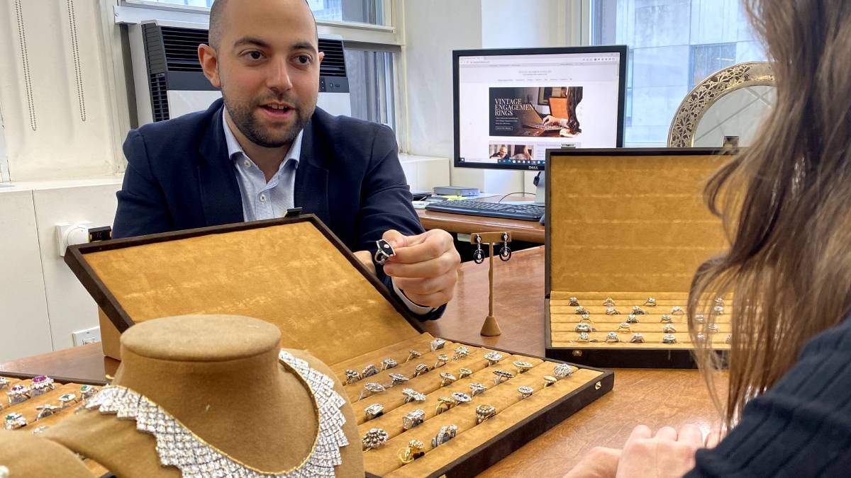 Benjamin giving engagement ring to customer from jewelry showroom