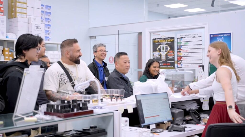 A crowd of people congregates in a jewellery store