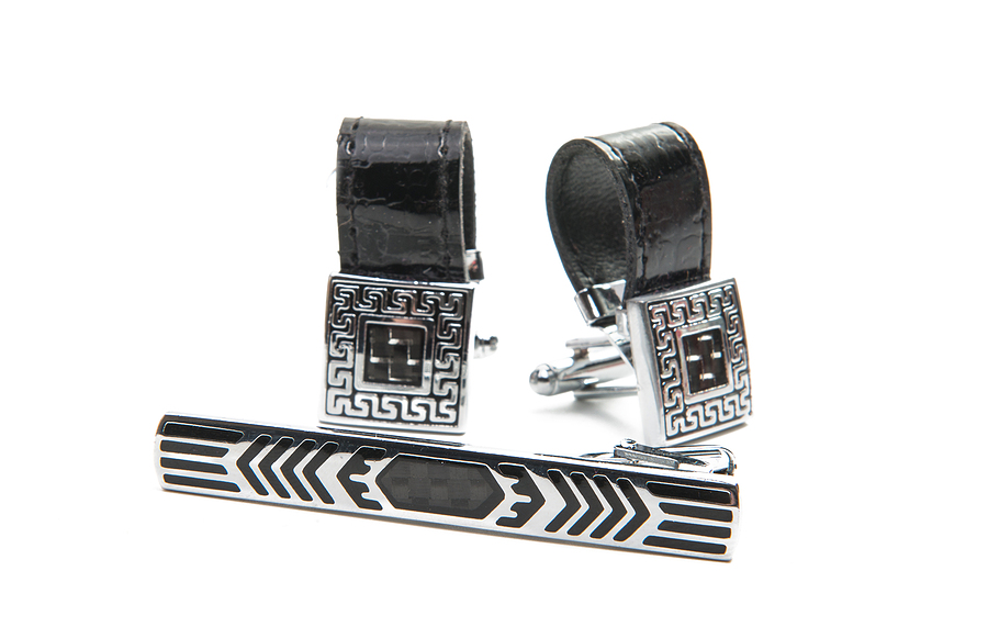 Two silver and black square cufflinks isolated on a white background.