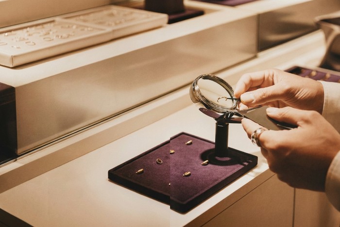 Banks dropping jewellers — a jeweller reviews a gold ring at the counter after receiving a bank exit letter