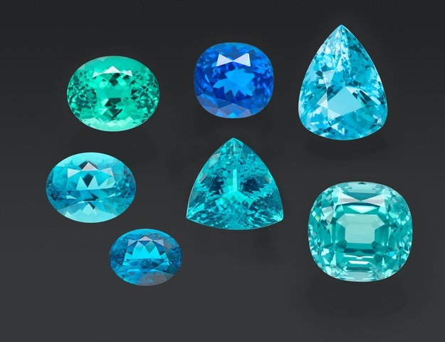A selection of copper-bearing tourmalines from Brazil, Mozambique, and Nigeria, and the two new samples (two oval stones on the bottom left), analyzed at SSEF.