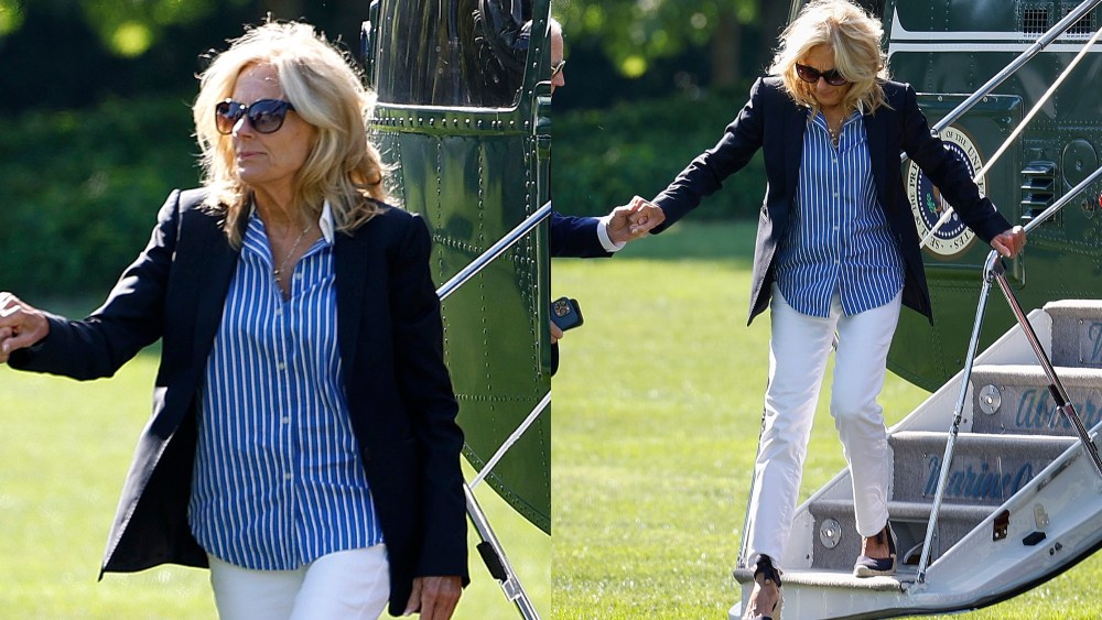 Jill Biden, in white pants, wedges, a blue and white pinstripe shirt and blazer, returns to the White House on Aug. 12 after a weekend trip to Delaware.