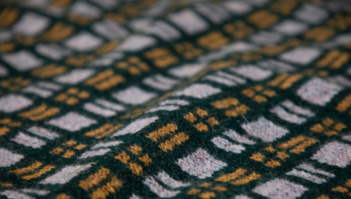 Sempiturnal Wrap showing knit plaid patterning